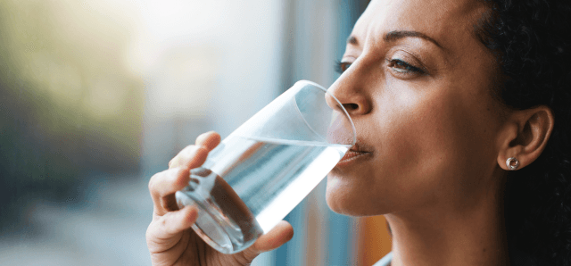 woman drinking a glass of water